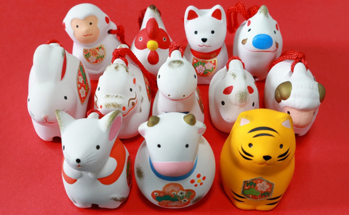 Assortment of colourful Japanese zodiac animal figures including a tiger, rabbit and ox 