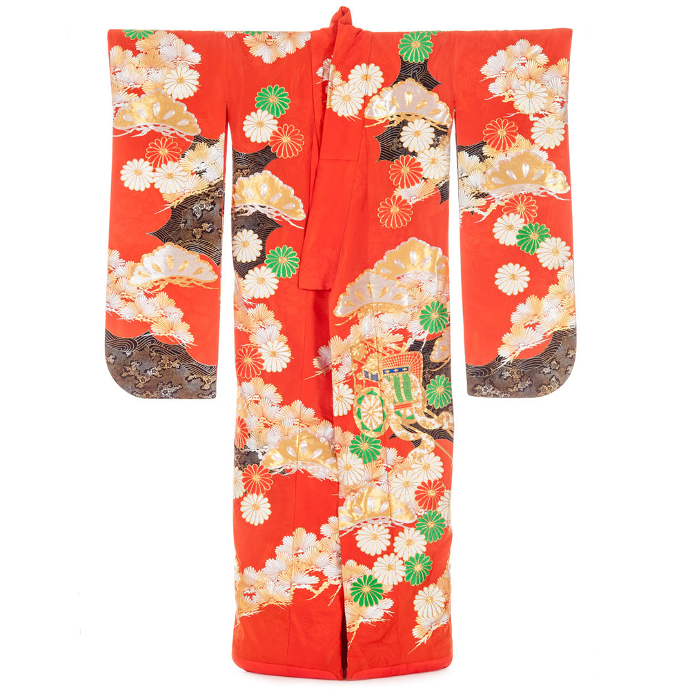 A vivid red kimono with white and yellow flowers, green details and mountain designs near the hem